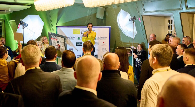 Cleanology's Dominic Ponniah hosts the charity auction during the event.